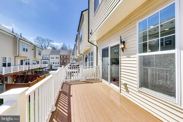 a view of a balcony with wooden floor and fence