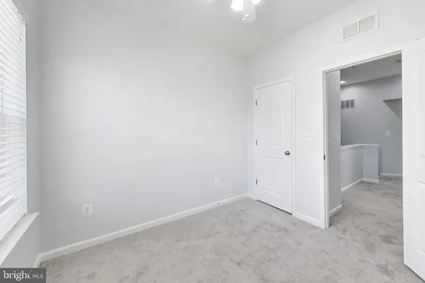 an empty room with windows and closet