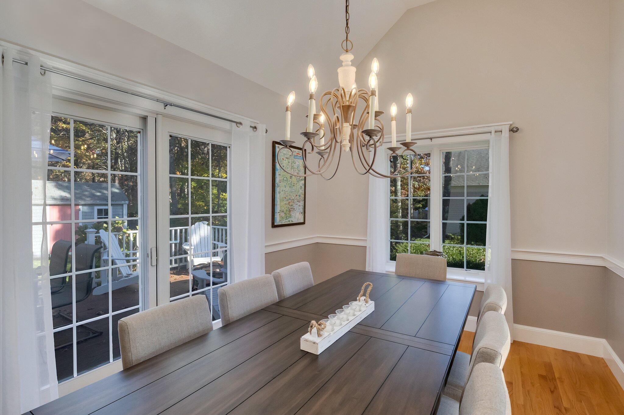 15 Regatta Drive Mashpee, MA 02649 - Photo 11 of 55 a living room with furniture and a chandelier