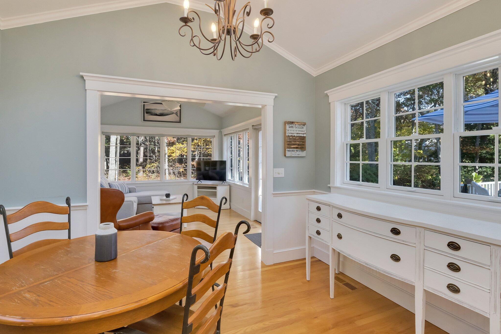 15 Regatta Drive Mashpee, MA 02649 - Photo 16 of 55 a view of a dining room with furniture wooden floor and chandelier