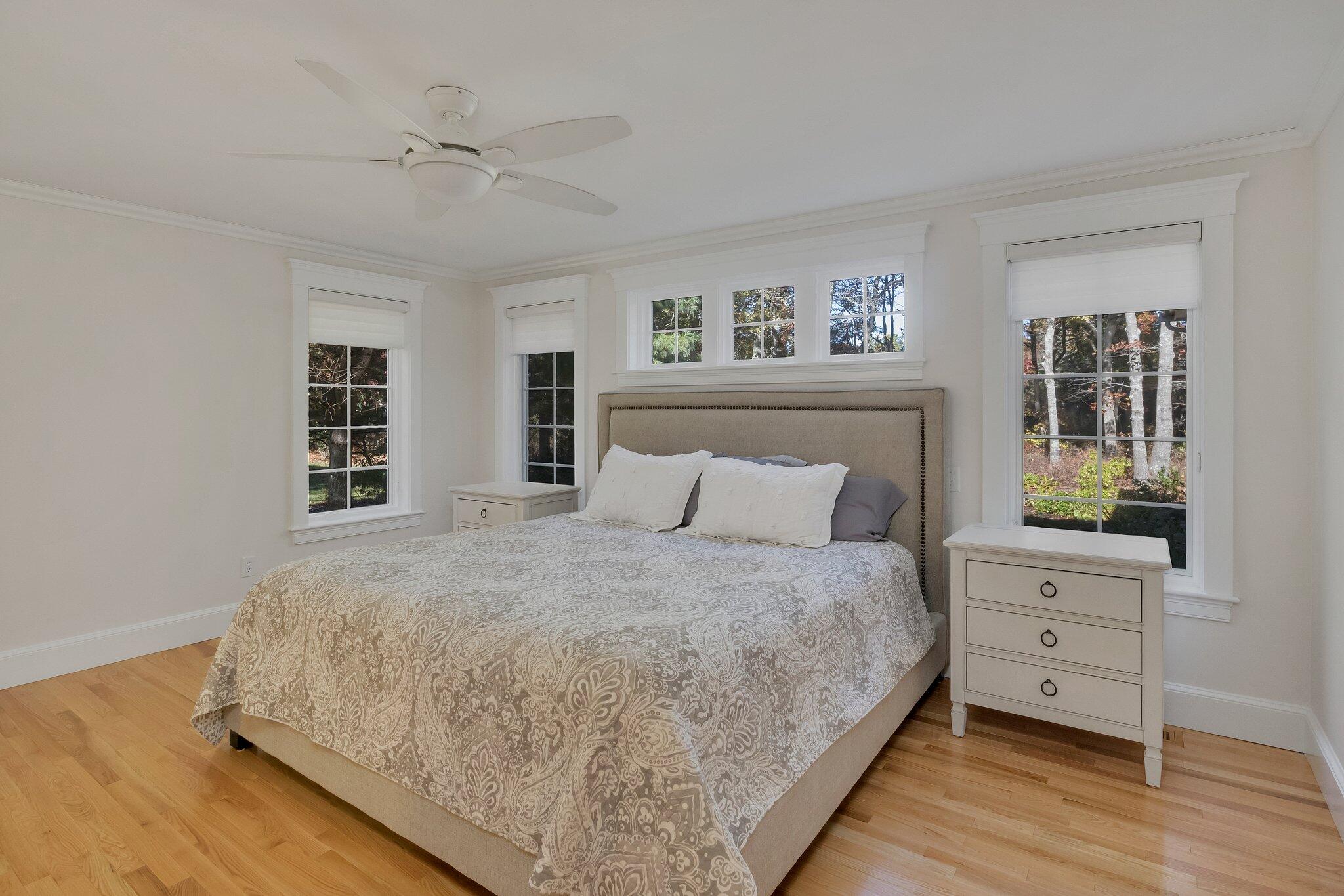 15 Regatta Drive Mashpee, MA 02649 - Photo 20 of 55 a large bed sitting in a bedroom next to a window and a dresser