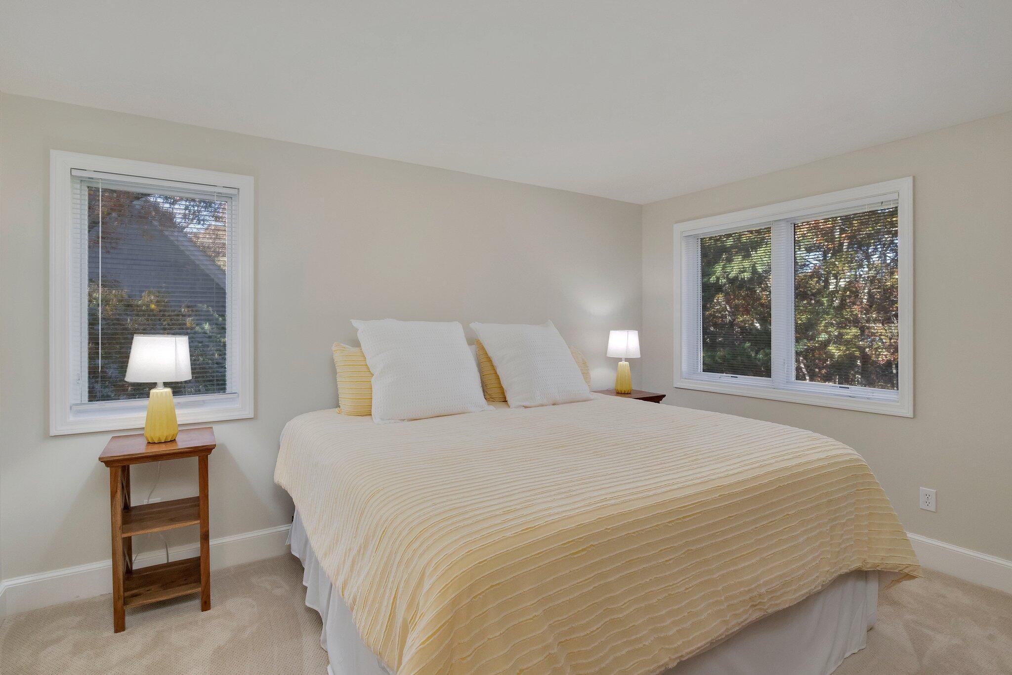 15 Regatta Drive Mashpee, MA 02649 - Photo 29 of 55 a bedroom with a bed and a lamp on dresser