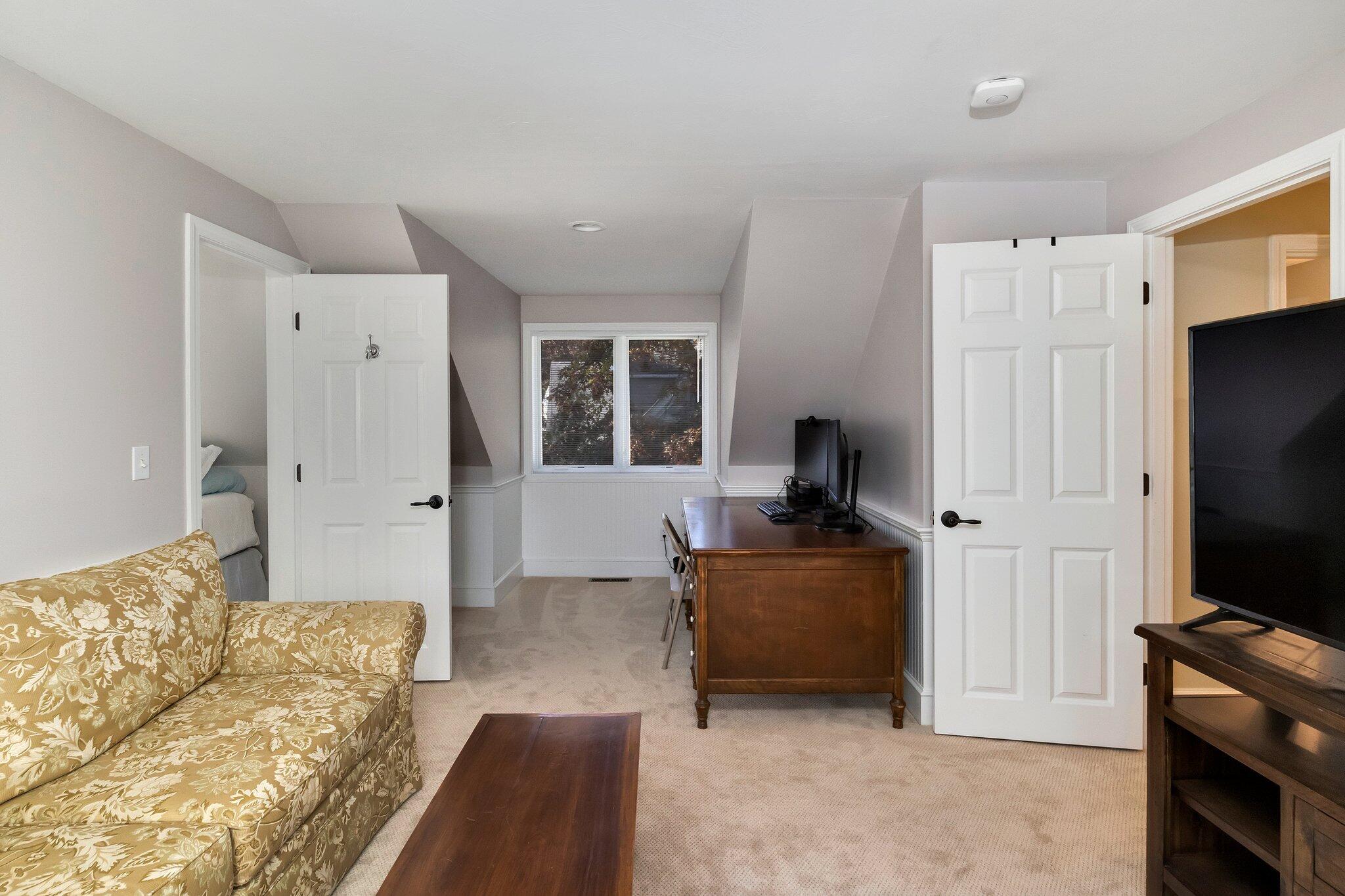 15 Regatta Drive Mashpee, MA 02649 - Photo 34 of 55 a bedroom with furniture and a flat screen tv