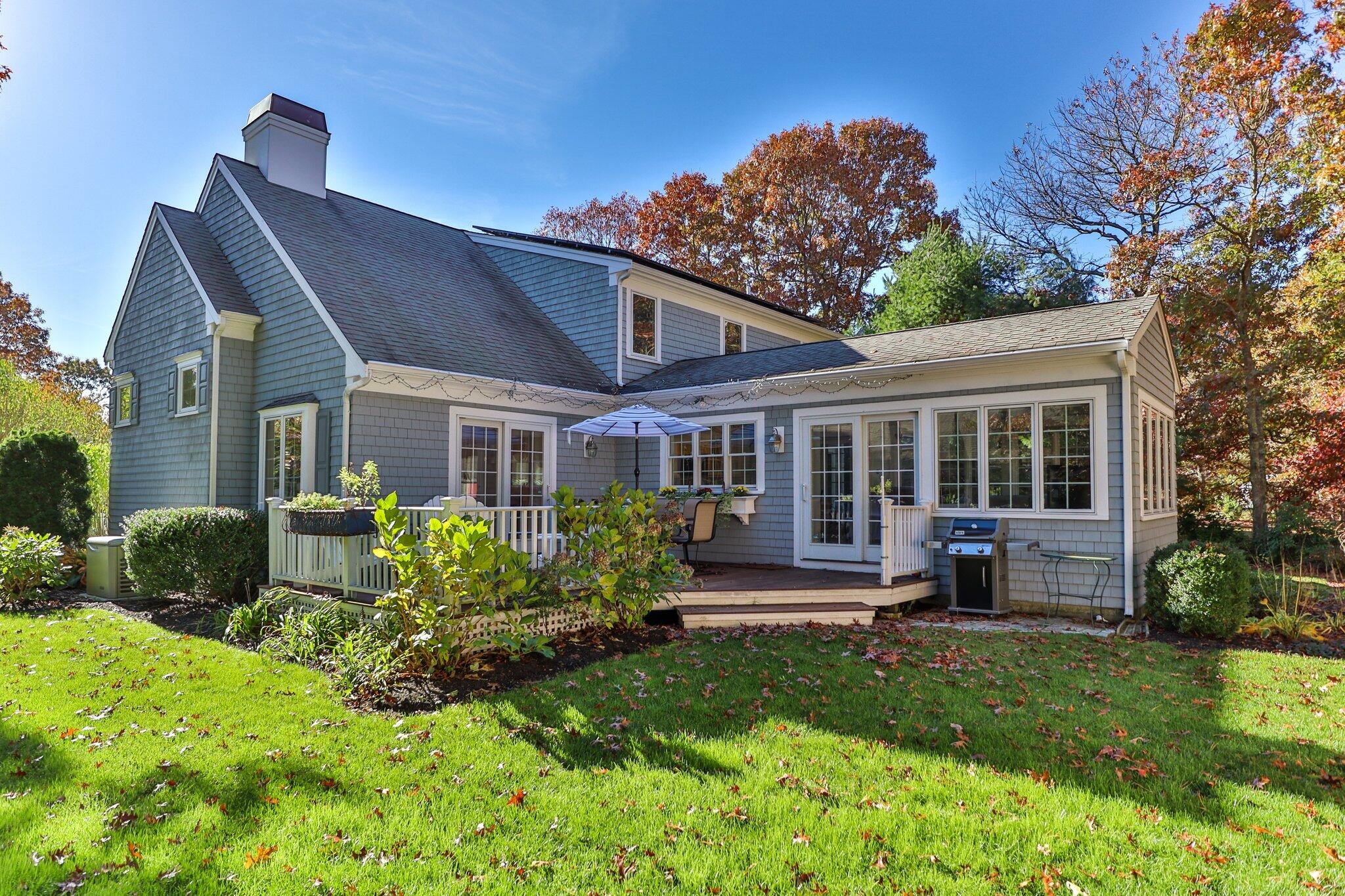 15 Regatta Drive Mashpee, MA 02649 - Photo 48 of 55 a front view of a house with a yard table and chairs