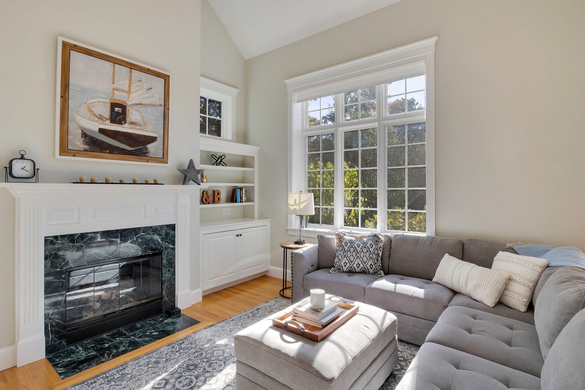 15 Regatta Drive Mashpee, MA 02649 - Photo 8 of 55 a living room with furniture and a fireplace