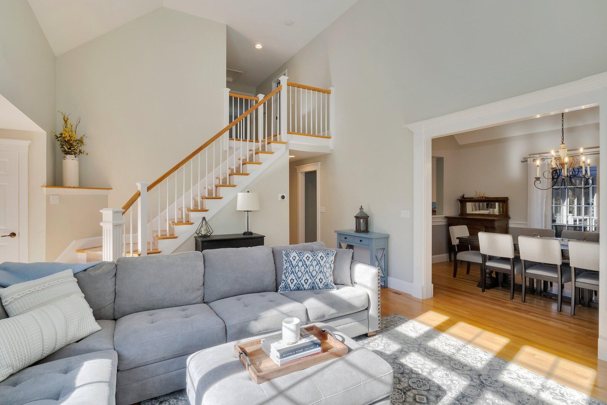 15 Regatta Drive Mashpee, MA 02649 - Photo 9 of 55 a living room with furniture and a dining table with wooden floor