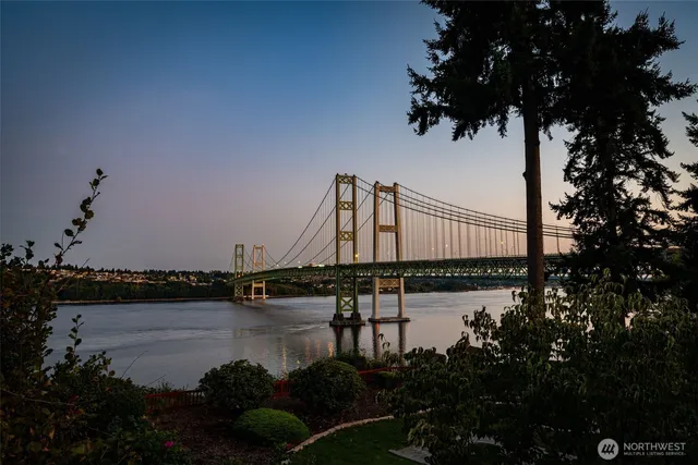 a view of a ocean with boats and trees in the background