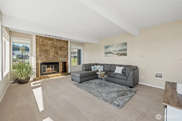 a kitchen with stainless steel appliances granite countertop a sink a stove and a refrigerator