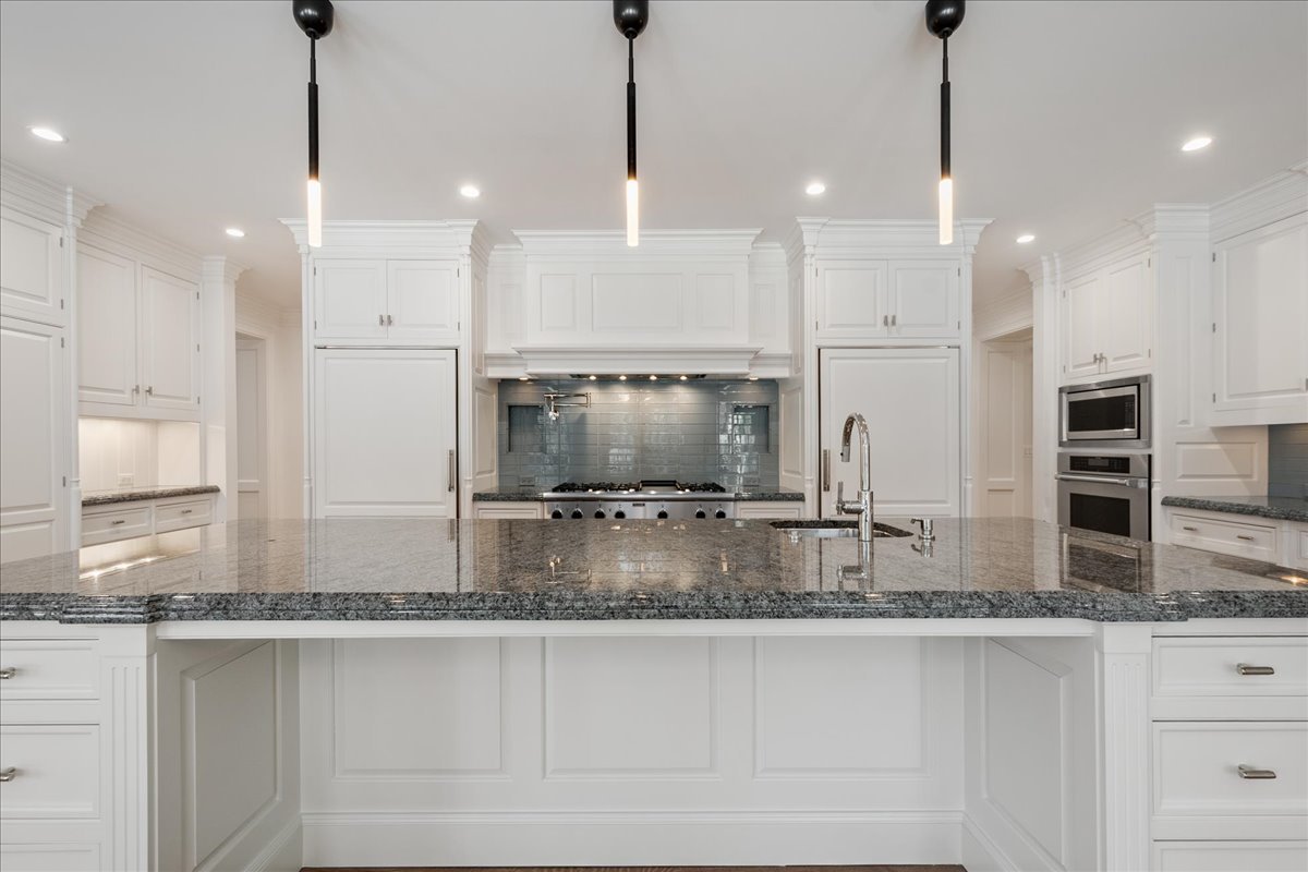 861 Bell Lane Winnetka, IL 60093 - Photo 11 of 57 a kitchen with kitchen island a counter top stainless steel appliances and cabinets