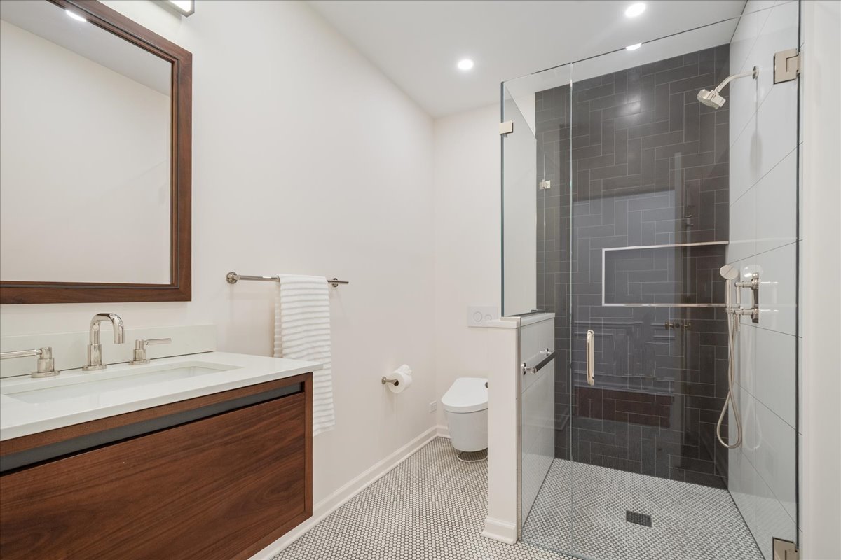 861 Bell Lane Winnetka, IL 60093 - Photo 27 of 57 a bathroom with a sink a toilet and shower