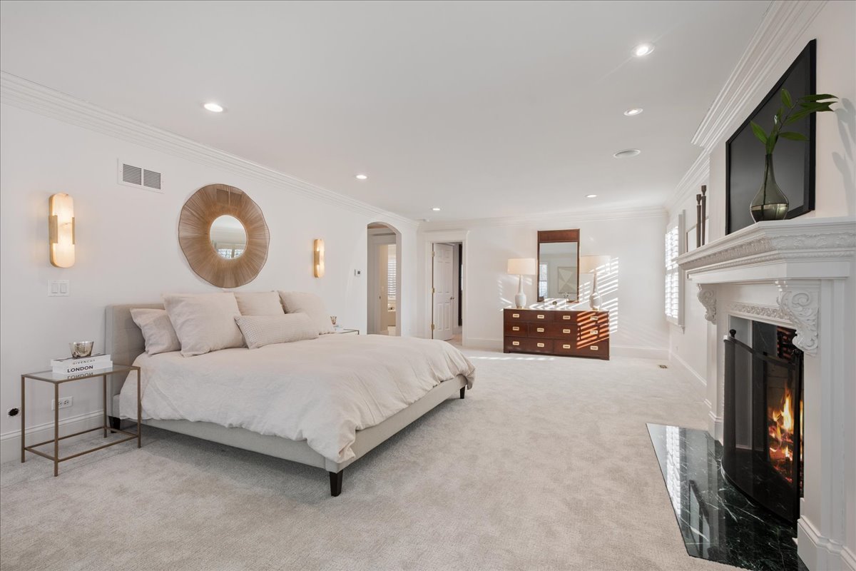 861 Bell Lane Winnetka, IL 60093 - Photo 29 of 57 a spacious bedroom with a bed and a fireplace