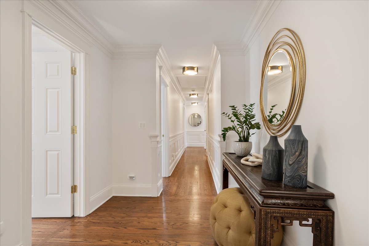 861 Bell Lane Winnetka, IL 60093 - Photo 36 of 57 a view of a hallway with wooden floor and a potted plant