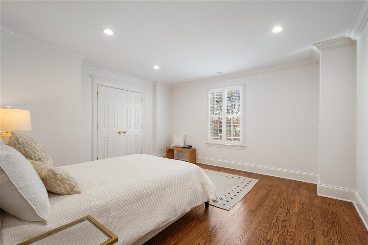 861 Bell Lane Winnetka, IL 60093 - Photo 39 of 57 a bedroom with a bed and wooden floor