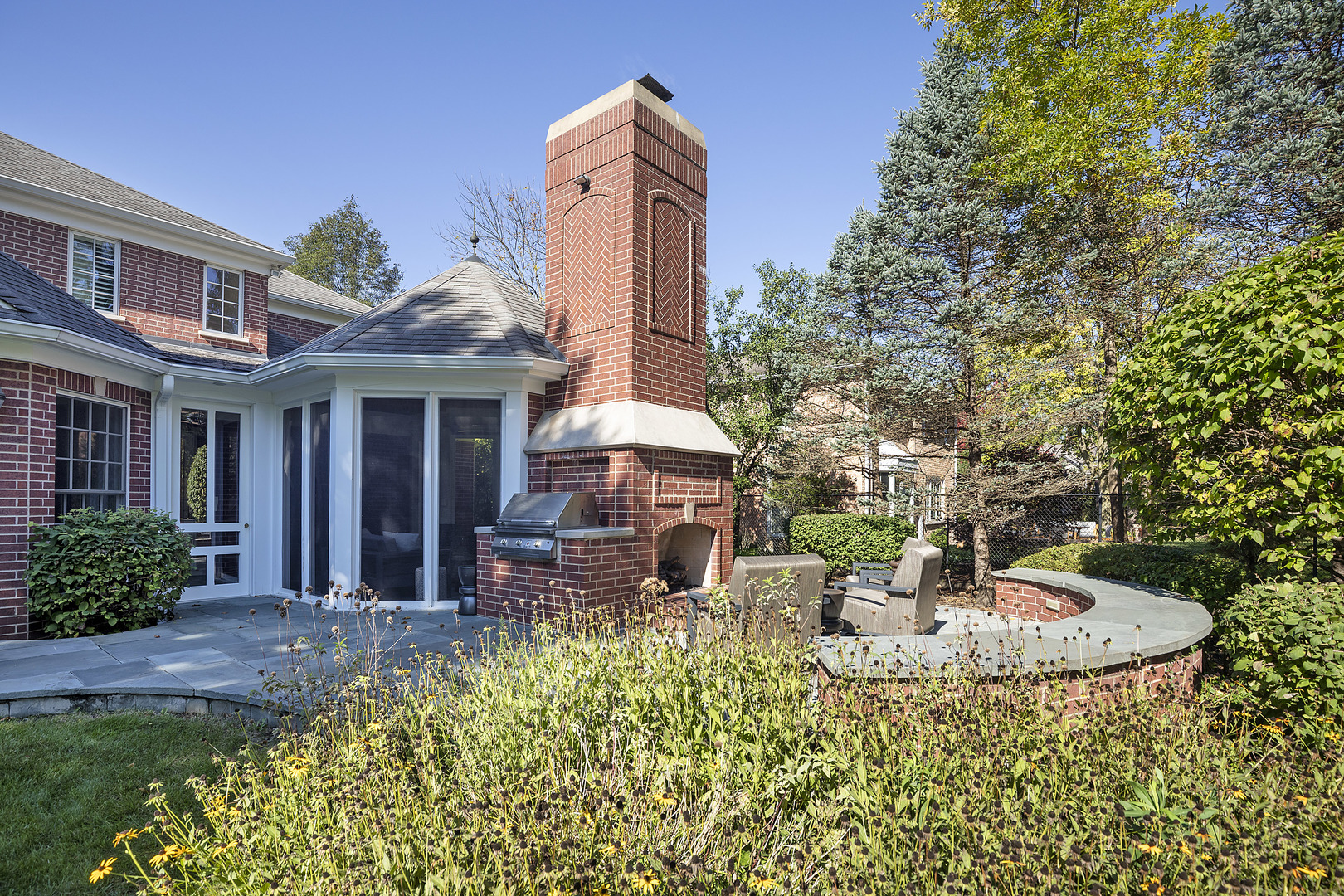 861 Bell Lane Winnetka, IL 60093 - Photo 49 of 57 a view of a house with patio and a garden