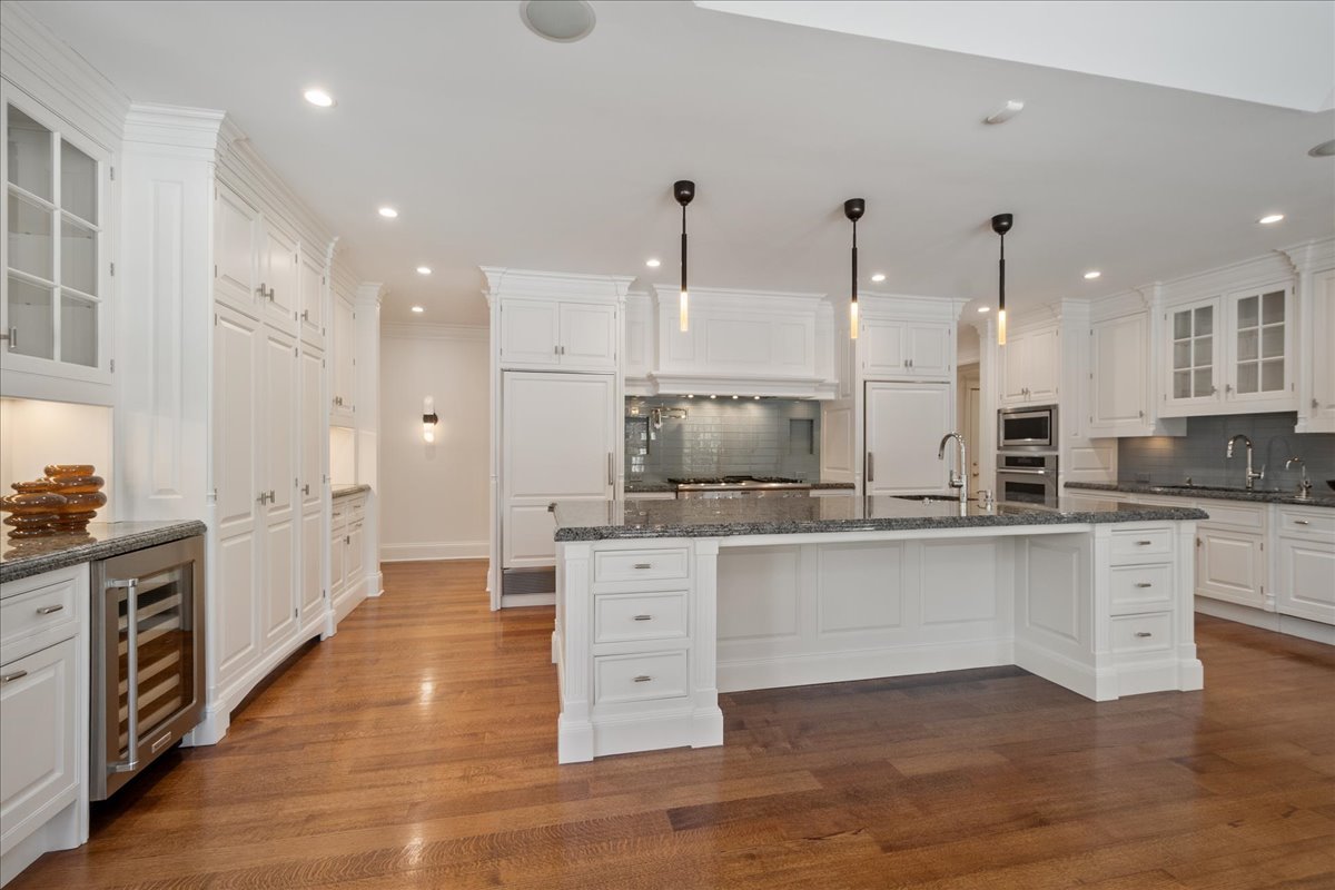 861 Bell Lane Winnetka, IL 60093 - Photo 10 of 57 a large kitchen with cabinets and wooden floor