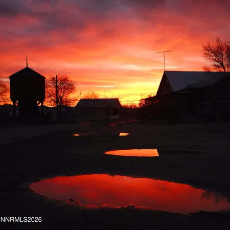 a sunset view with a lake