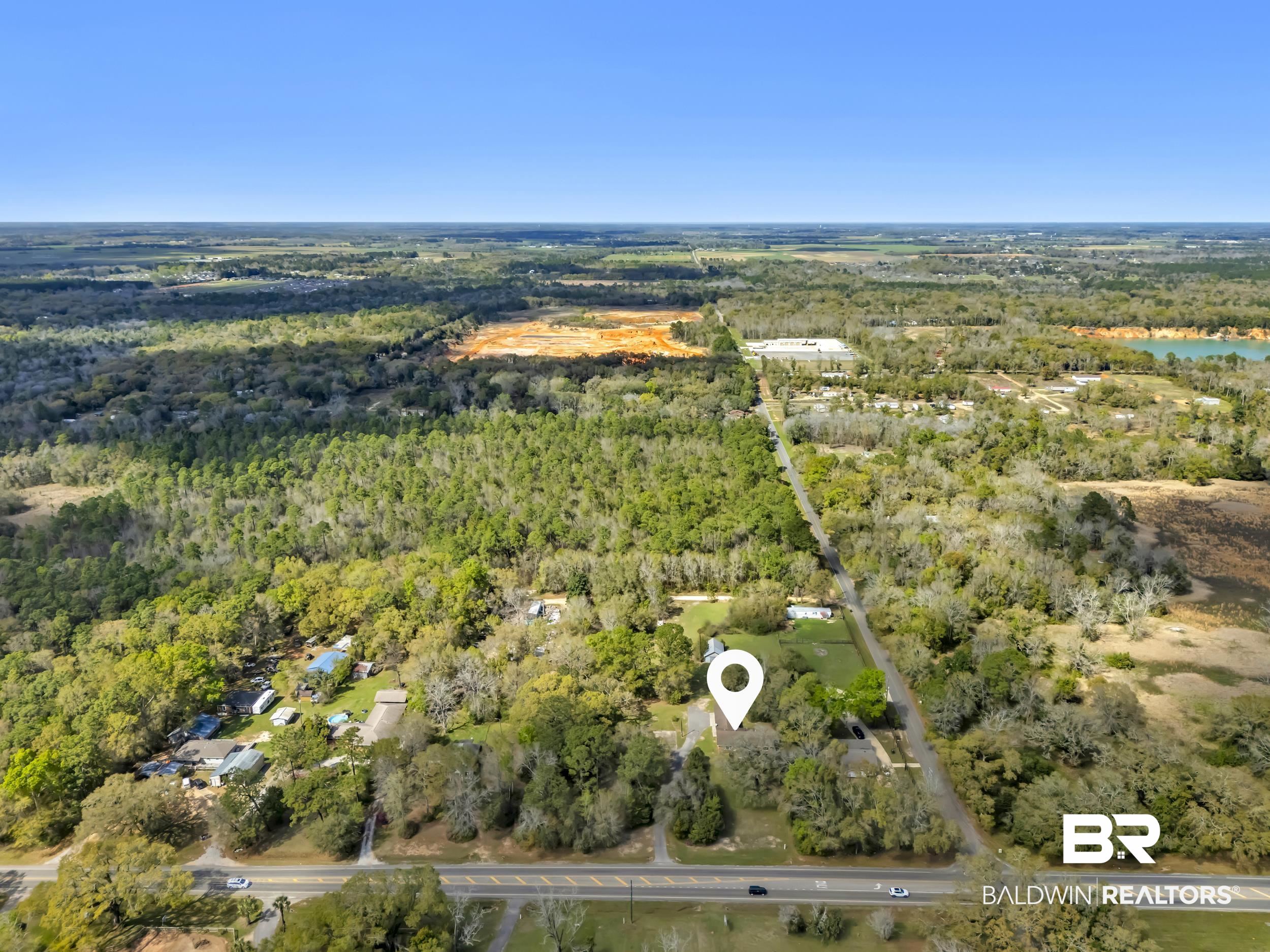 17463 Highway 98 Foley, AL 36535 - Photo 52 of 57 Bird's eye view of a heavily wooded area and a large body of water