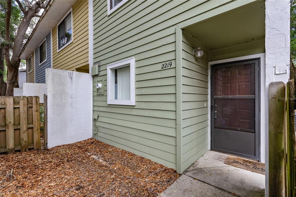 2219 Southwest 39th Way Gainesville, FL 32607 - Photo 1 of 17 a view of a house with a door and wooden walls