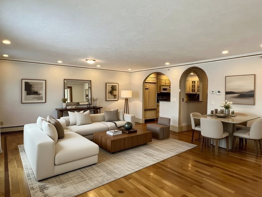 1002 Beacon Street Brookline, MA 02446 - Photo 12 of 17 a living room with furniture a mirror and a large window