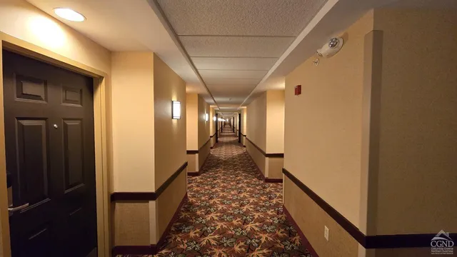 a view of hallway with wooden floor