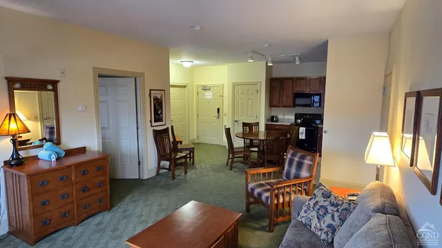 a kitchen with sink refrigerator dining table and chairs