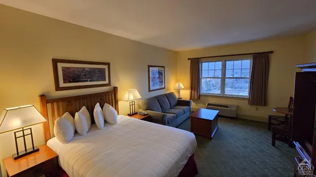 a living room with furniture and a lamp