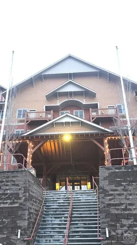 a living room with fireplace furniture and a large window