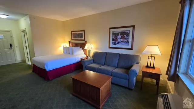 a bedroom with furniture and a large window