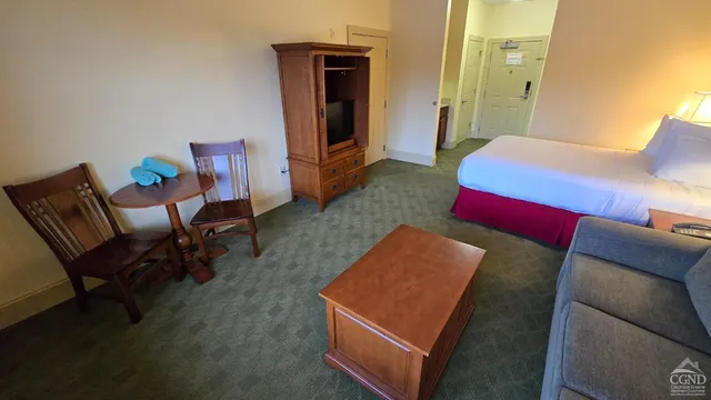a bedroom with a bed and a couch