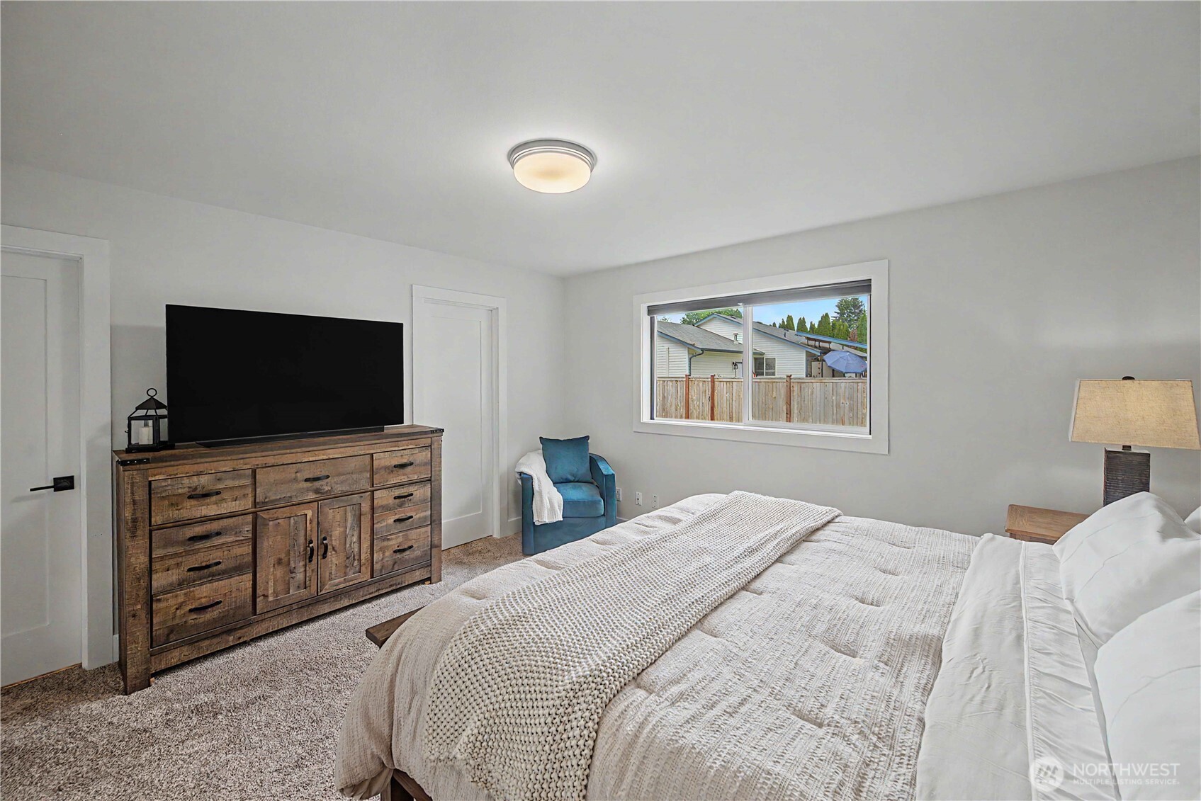 20919 Ronning Road Arlington, WA 98223 - Photo 18 of 28 a bedroom with a large bed and a flat screen tv