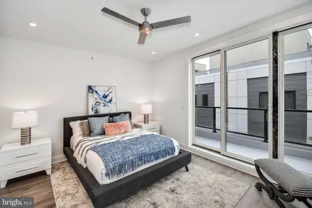 a bedroom with a large bed and a chandelier