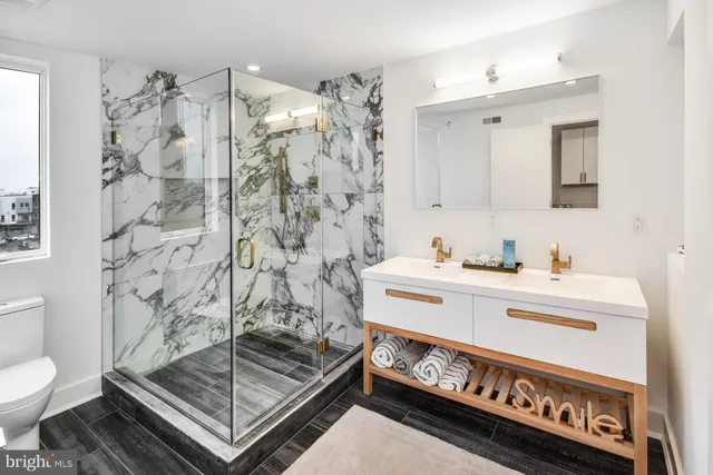 a bathroom with a sink toilet and shower