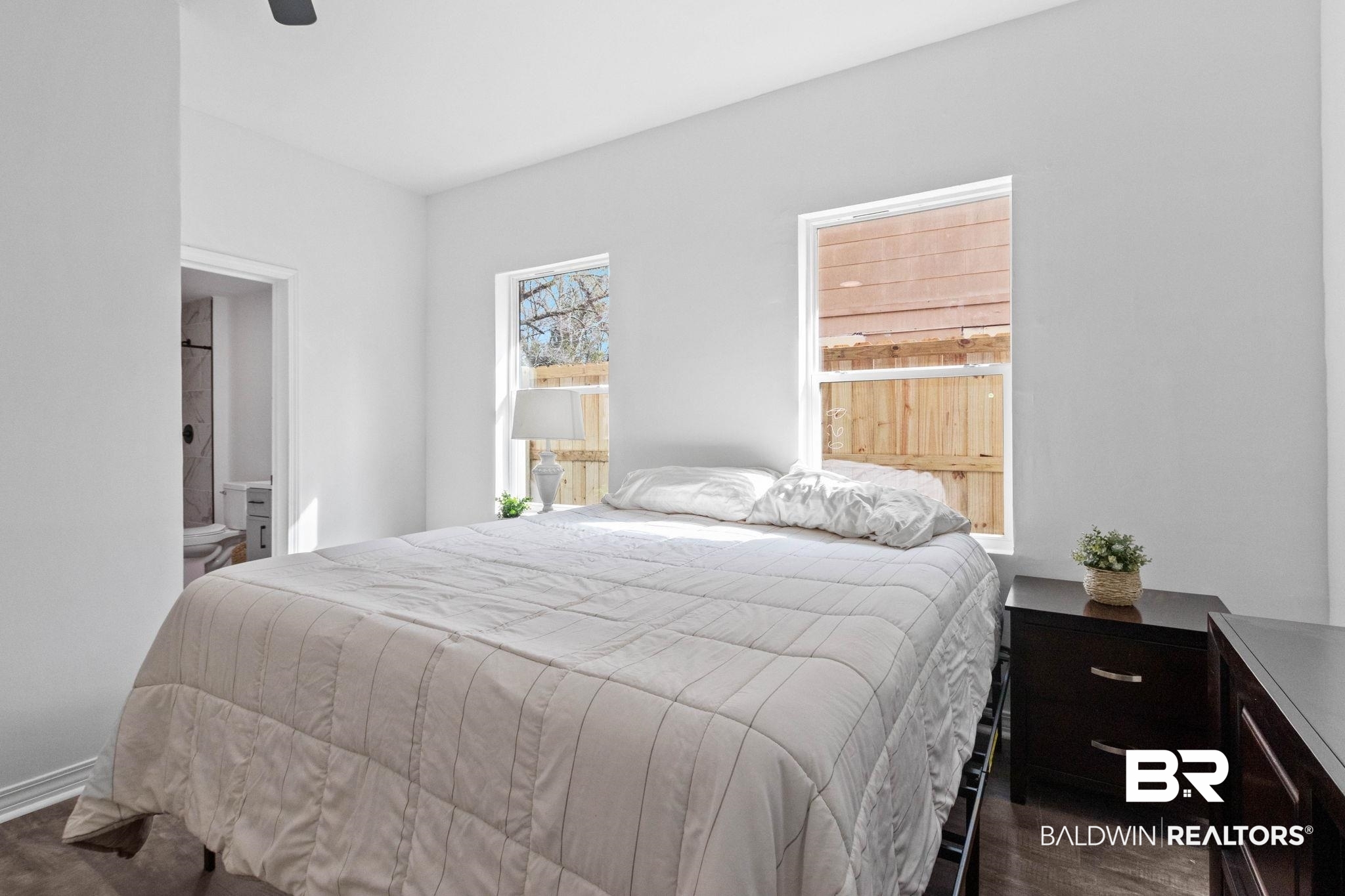 128 Bush Avenue Mobile, AL 36604 - Photo 20 of 40 Bedroom with a ceiling fan, ensuite bathroom, and dark wood-style floors