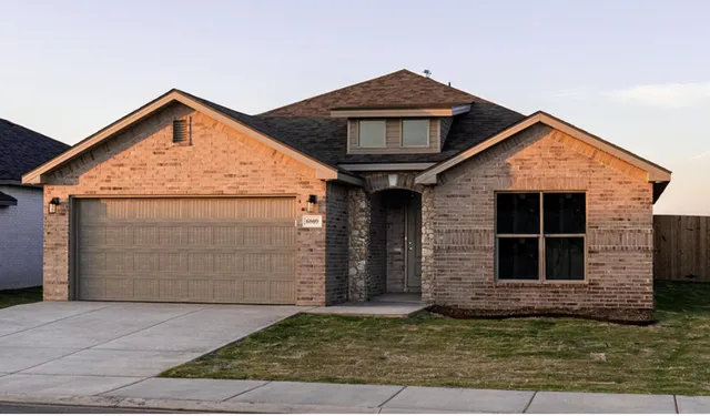 a front view of a house with garage
