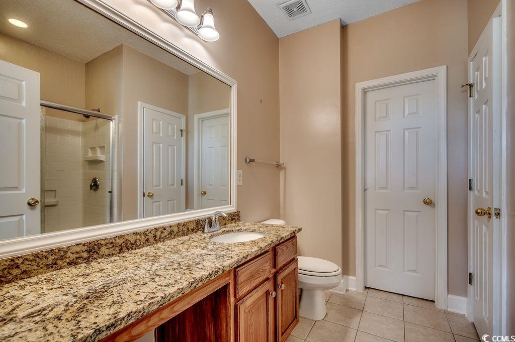 100 Culpepper Way, Unit 1002 Myrtle Beach, SC 29579 - Photo 15 of 39 Full bathroom with tile patterned floors, a tile shower, and vanity