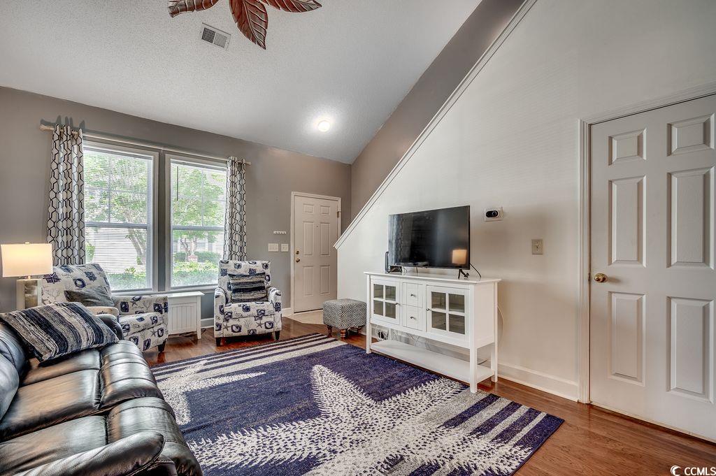 100 Culpepper Way, Unit 1002 Myrtle Beach, SC 29579 - Photo 2 of 39 Living room with vaulted ceiling and wood finished floors