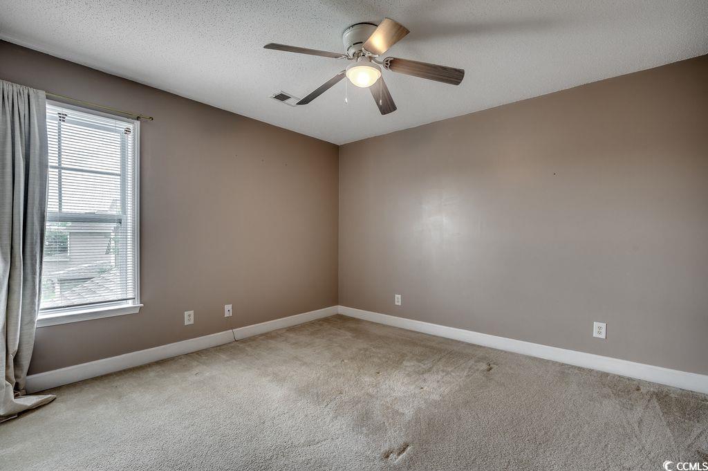 100 Culpepper Way, Unit 1002 Myrtle Beach, SC 29579 - Photo 22 of 39 Carpeted empty room featuring baseboards and a ceiling fan