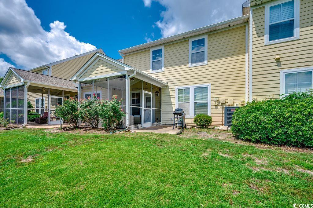 100 Culpepper Way, Unit 1002 Myrtle Beach, SC 29579 - Photo 26 of 39 Back of house featuring a sunroom and a lawn