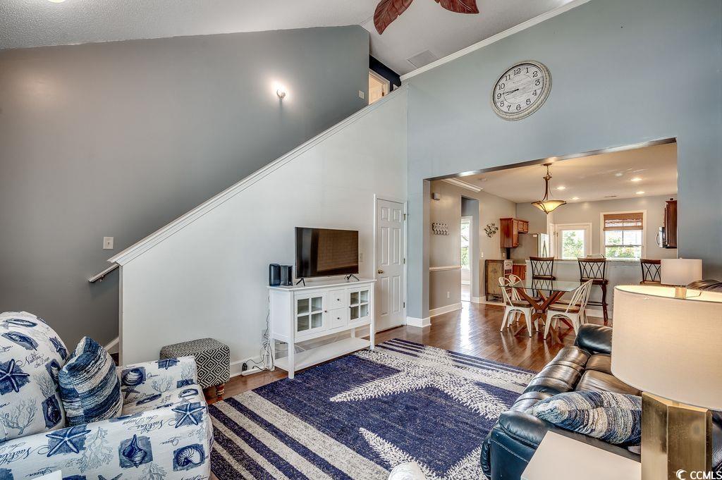 100 Culpepper Way, Unit 1002 Myrtle Beach, SC 29579 - Photo 3 of 39 Living area with wood finished floors and high vaulted ceiling