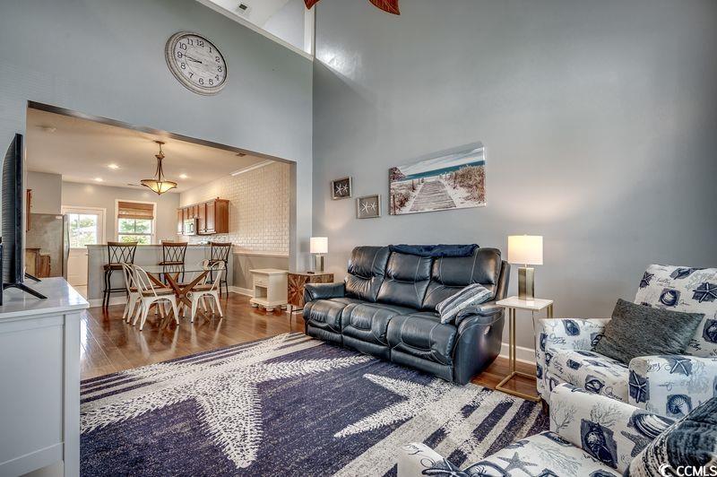 100 Culpepper Way, Unit 1002 Myrtle Beach, SC 29579 - Photo 4 of 39 Living area featuring wood finished floors and a towering ceiling