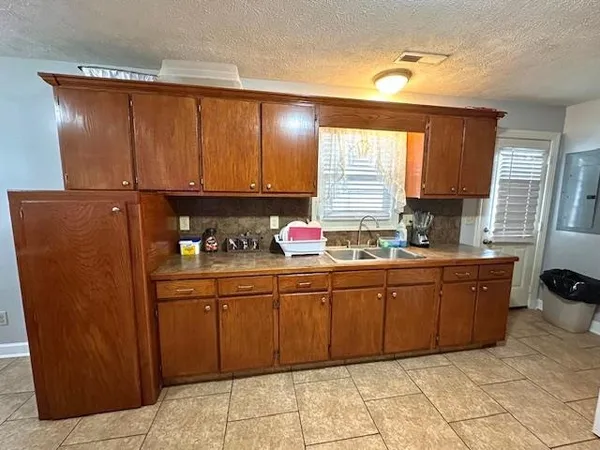 a kitchen with stainless steel appliances granite countertop a sink and cabinets
