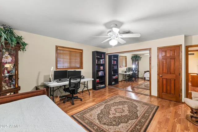 a living room with furniture a flat screen tv and a floor to ceiling window