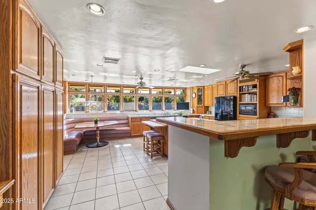 a living room filled with furniture and large windows
