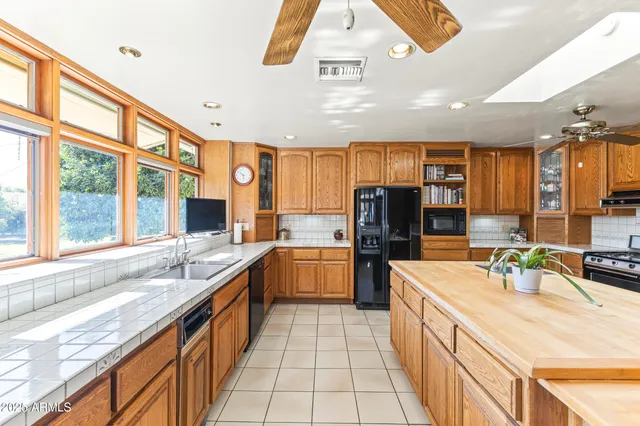 a front view of a house with outdoor seating and barbeque oven