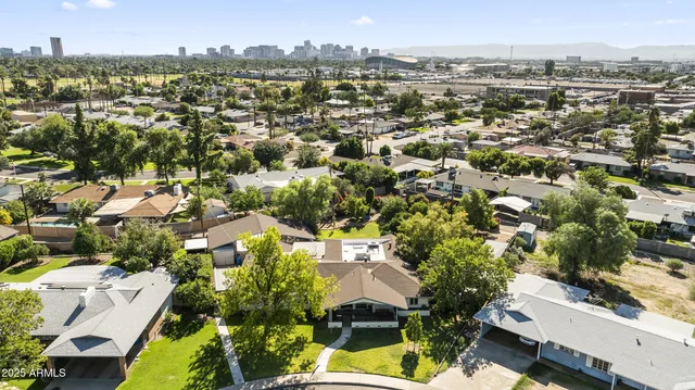 an aerial view of a residential houses with yard