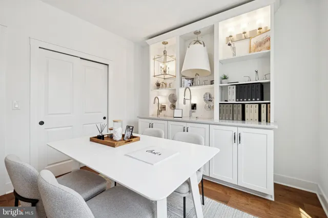a dining room with furniture and wooden floor
