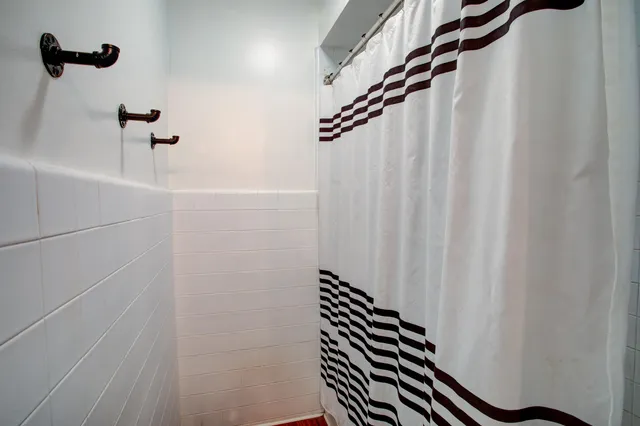 a bathroom with a shower and a shower