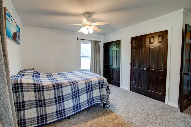 a bedroom with a bed and a chandelier
