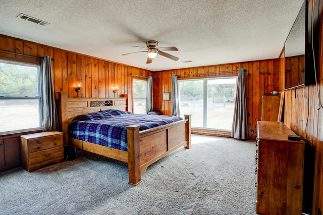 a bedroom with a bed and large window