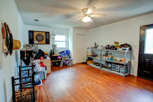 a living room with lots of furniture and a wooden floor